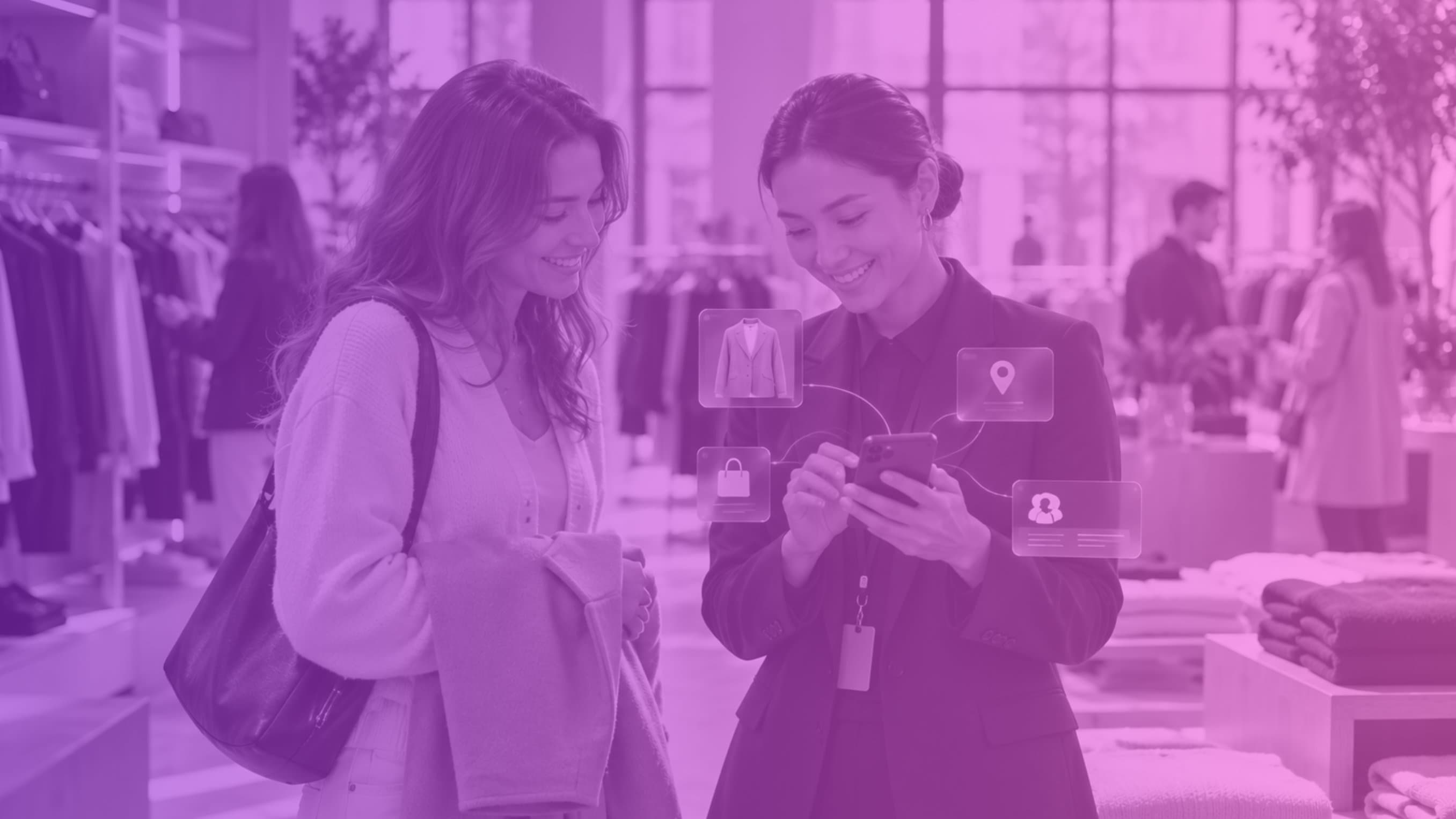 A store associate checks product, location and customer details on a phone while helping a smiling shopper in a clothing store