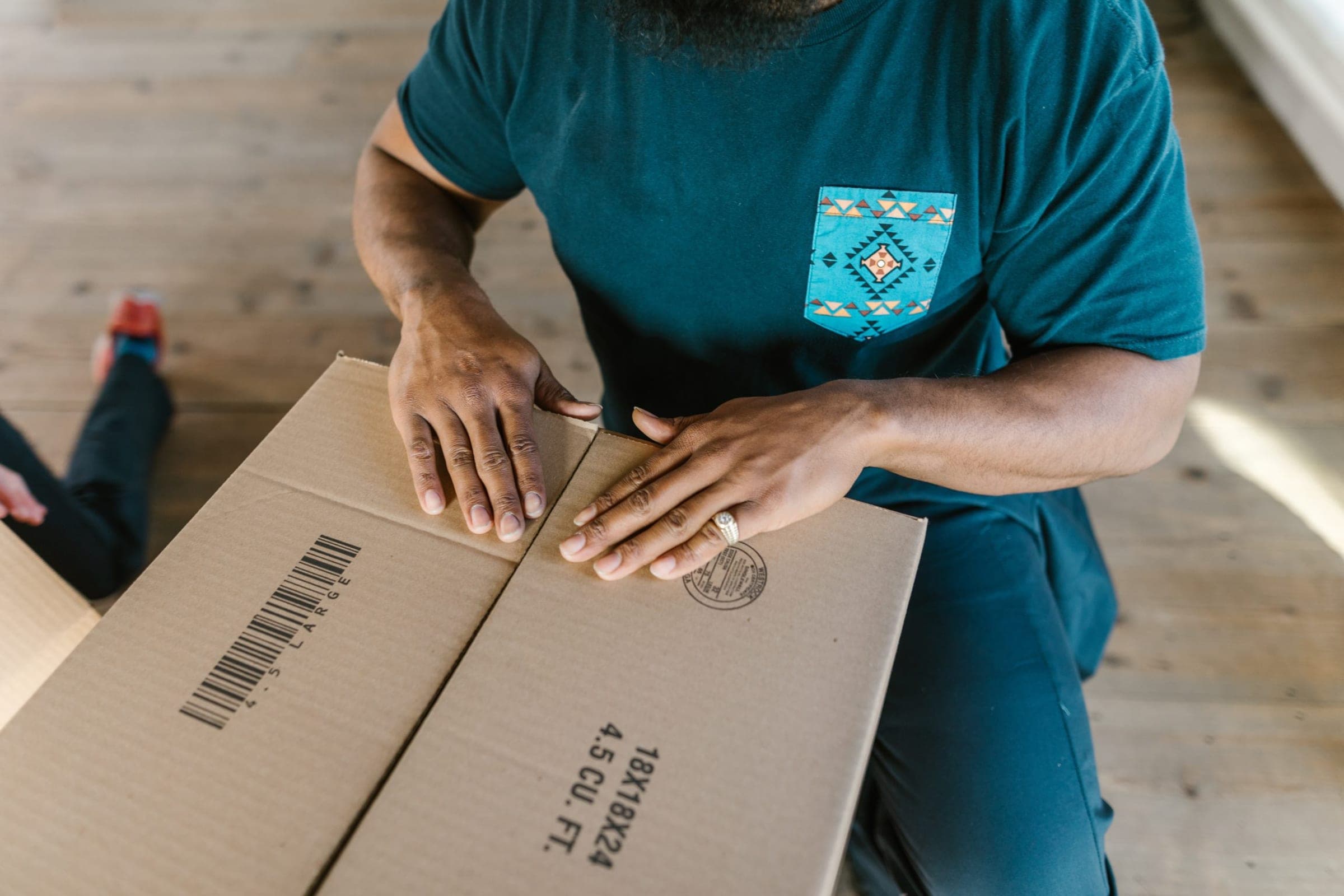 Man packing a brown box