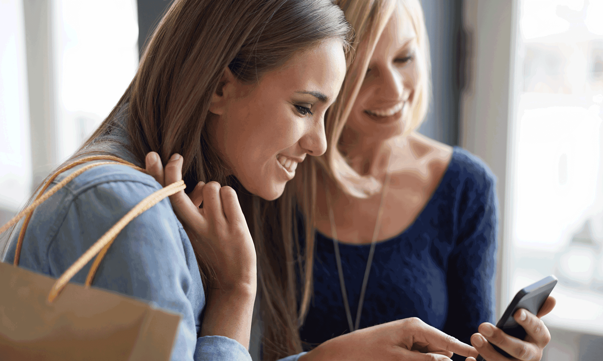 A store associate uses a mobile phone to access customer data during an in-store clienteling interaction.