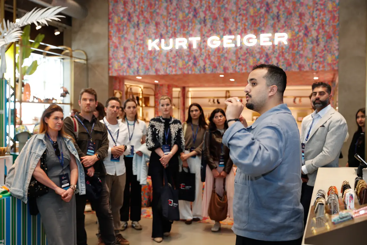 A store tour for Endless Aisle Live guests inside Kurt Geiger, with a host talking the group through the space