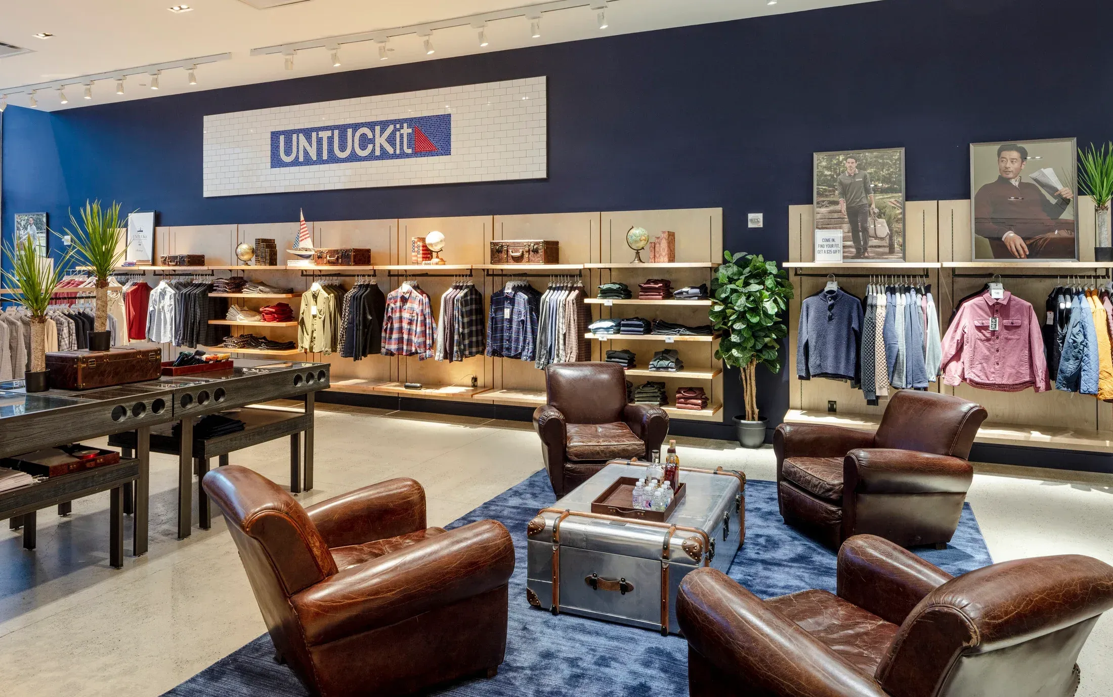 An UNTUCKit associate helping a customer in store